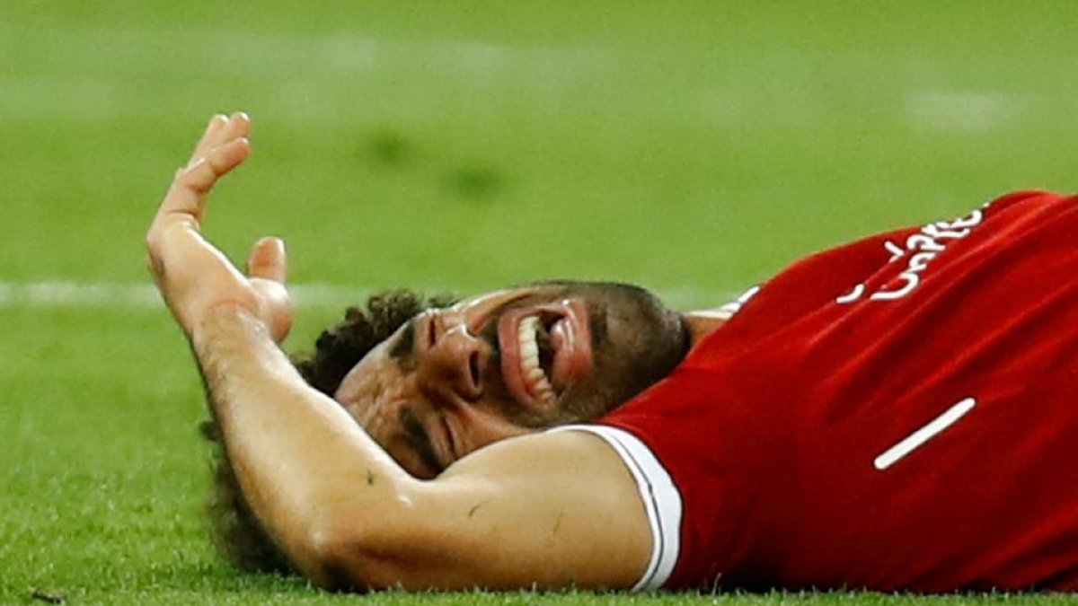 Salah, tras caer lesionado después de una entrada de Ramos.-/ KAI PFAFFENBACH (REUTERS)