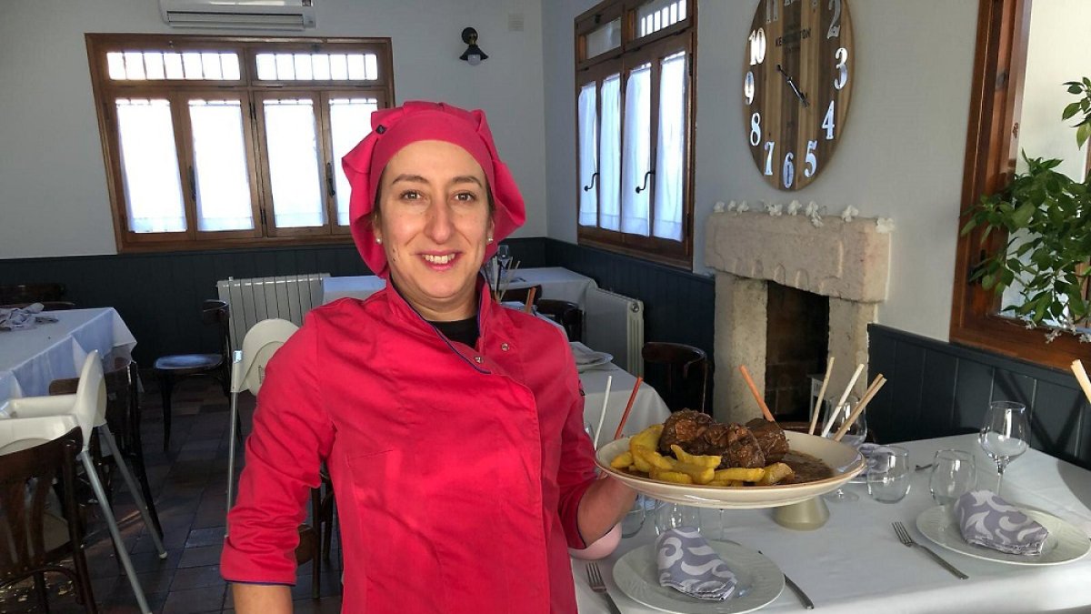 Virginia Rico con uno de sus guisos en el comedor del restaurante La Farola de Velilla