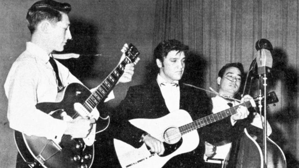 Elvis Presley, en una actuación en el verano de 1957, con Scotty Moore (guitarra) y Bill Black (contrabajo).-EL PERIÓDICO