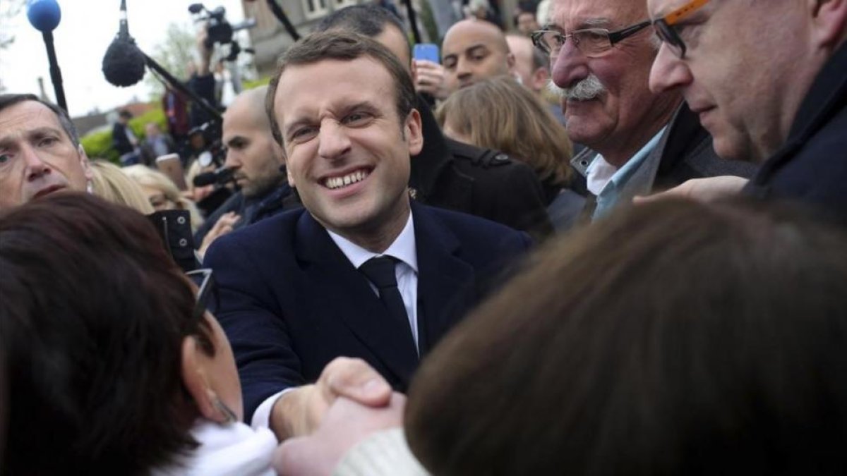 Macron saluda a simpatizantes tras votar en Le Touquet (norte).-THIBAUT CAMUS