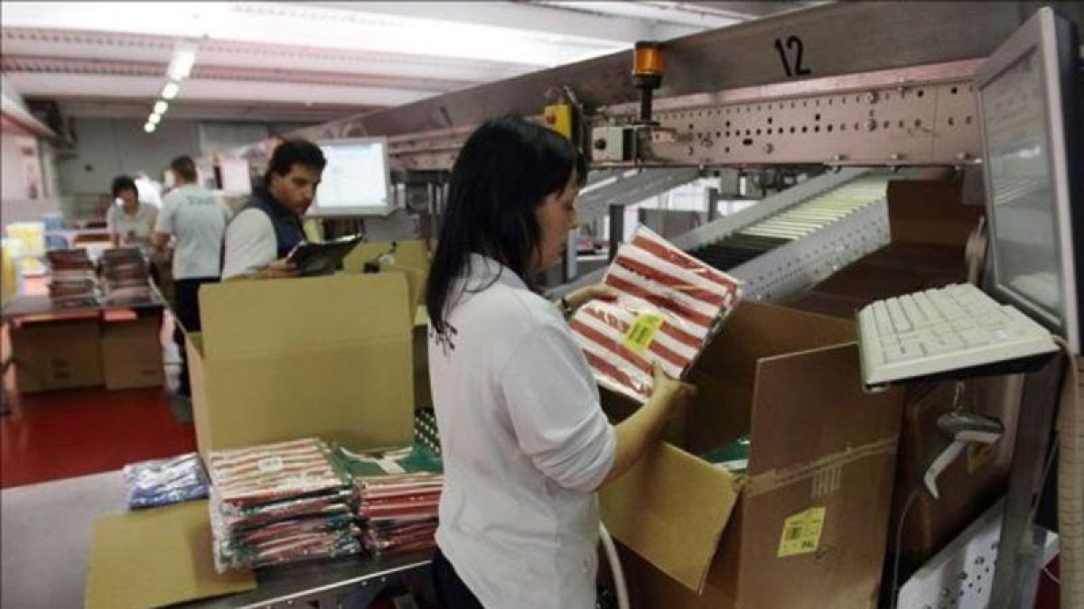 Empleados y empleadas en una empresa textil.-REUTERS / ALBERT GEA