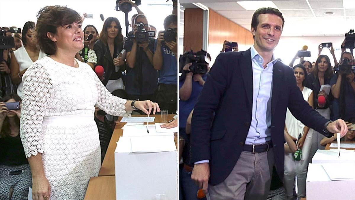 Soraya Sáenz de Santamaría y Pablo Casado, en el momento de depositar sus respectivos votos.-EL PERIÓDICO