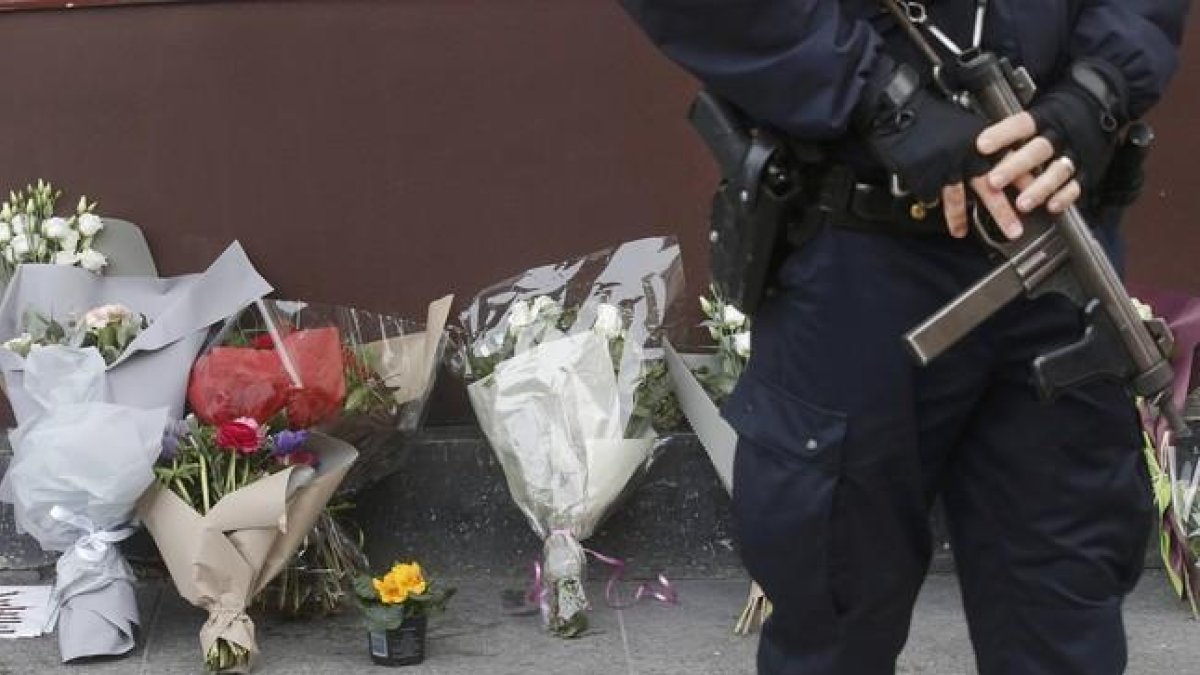Un policía permanece de guardia frente al resturante 'Le Carrillon'.-CHRISTIAN HARTMANN / REUTERS