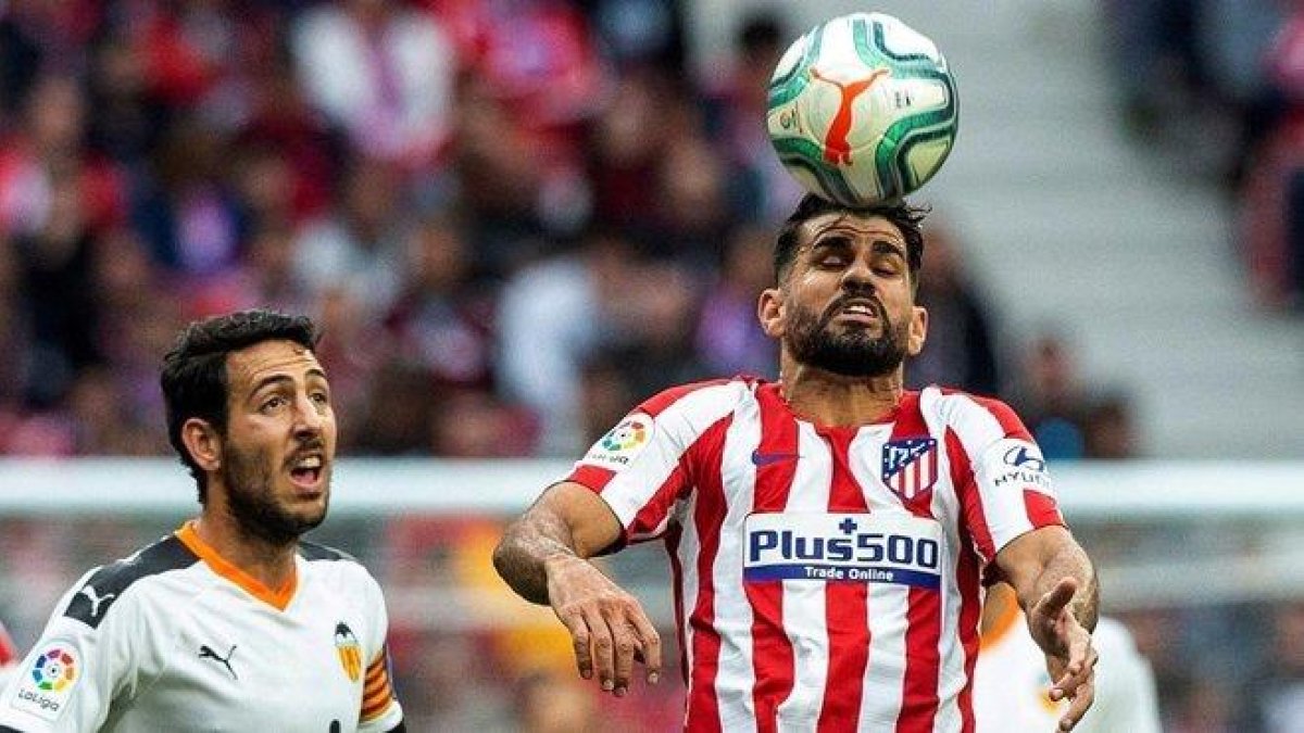 Diego Costa cabecea ante Parejo.-EFE / RODRIGO JIMÉNEZ