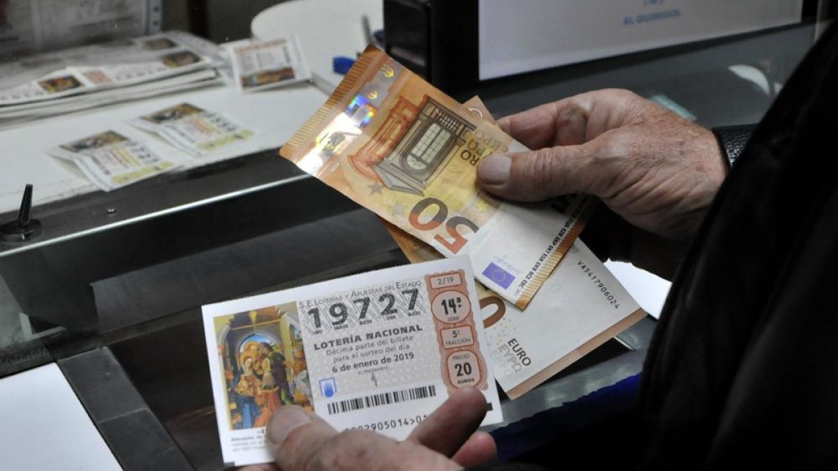 Una persona adquiere un décimo del Niño en Soria para una edición anterior del sorteo.-VALENTÍN GUISANDE