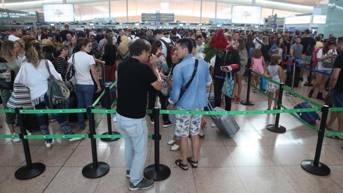 Colas en los controles de seguridad de El Prat este jueves.-ELISENDA PONS