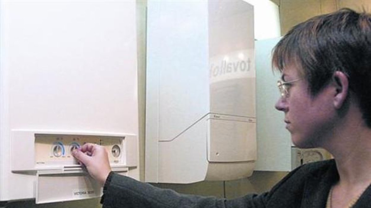 Una clienta prueba un aparato de calefacción con gas natural.-EL PERIÓDICO