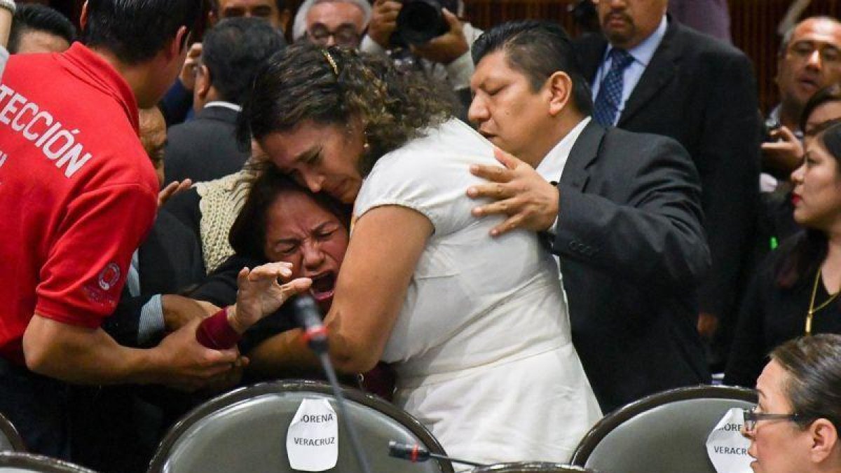 Legisladores reconfortan  a la diputada Carmen Medel Palma del Movimiento Regeneracion Nacional  Morena   luego de que recibiera la noticia de que su hija habia sido asesinada.-EFE