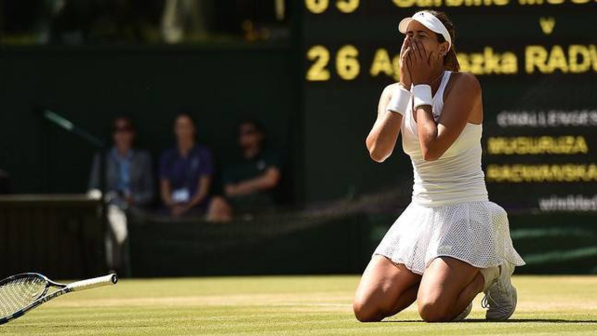 La tenista española Garbiñe Muguruza, arrodillada sobre el césped de Wimbledon, tras ganar a la polaca Agnieszka Radwanska y pasar a la final.-Foto: AFP / LEON NEAL