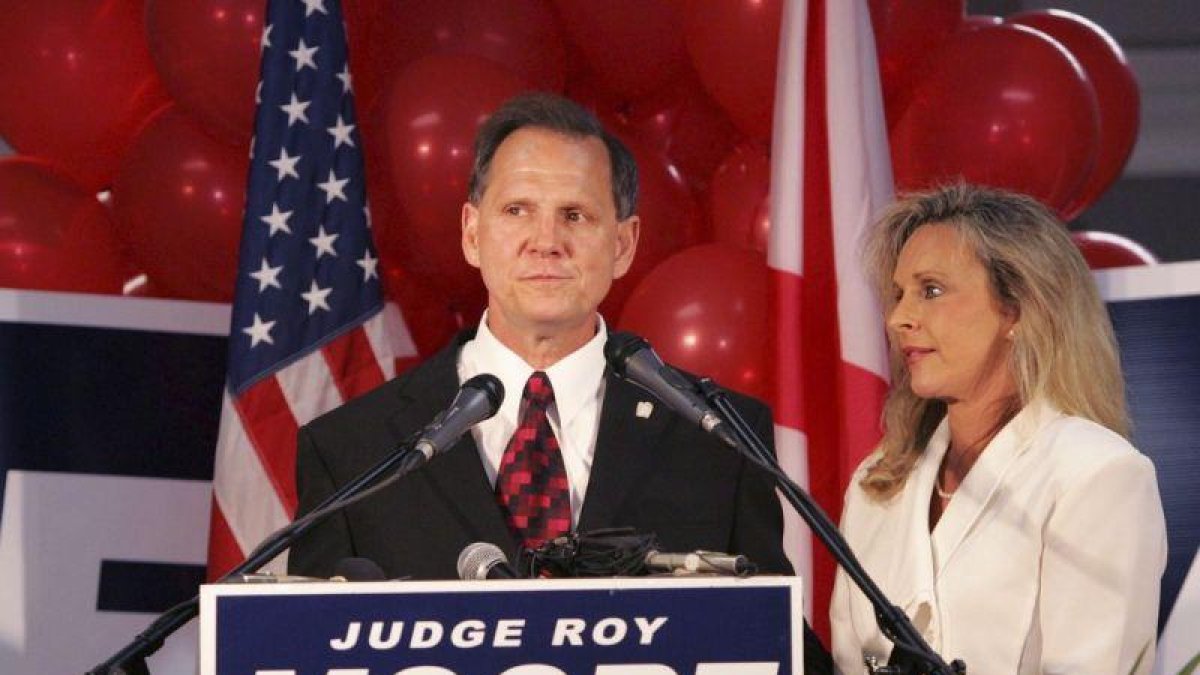 El candidato republicano para las elecciones legislativas en Alabama, Roy Moore, en un acto de campaña acompañado por su esposa.-AP / BUTCH DILL (AP)