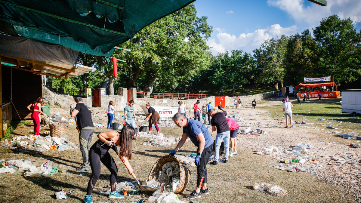 Miembros de las peñas sanjuaneras recogen la basura acumulada durante el Desencajonamiento.