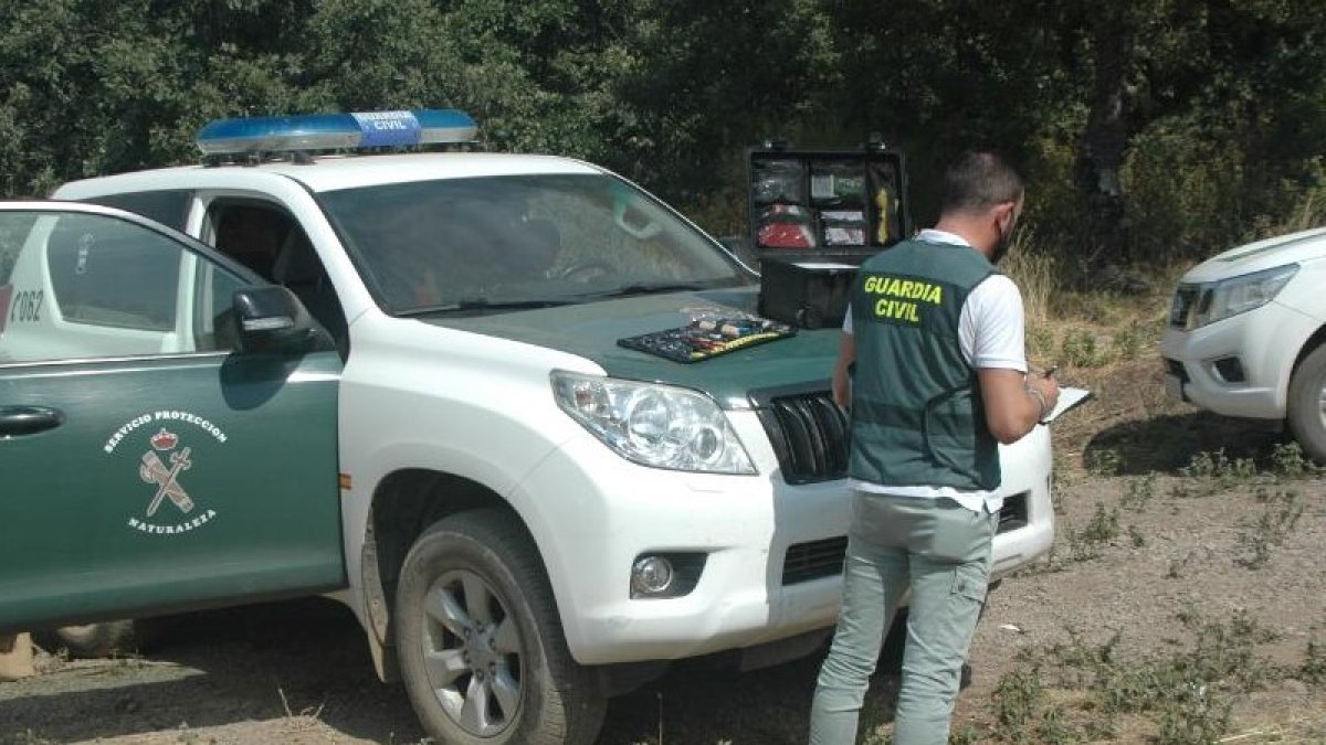 Imagen de archivo de un vehículo de la Guardia Civil y un agente.