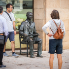 Ciudadanos viendo el aspecto que presenta la estatua de Machado de la plaza del Vergel.-G. MONTESEGURO